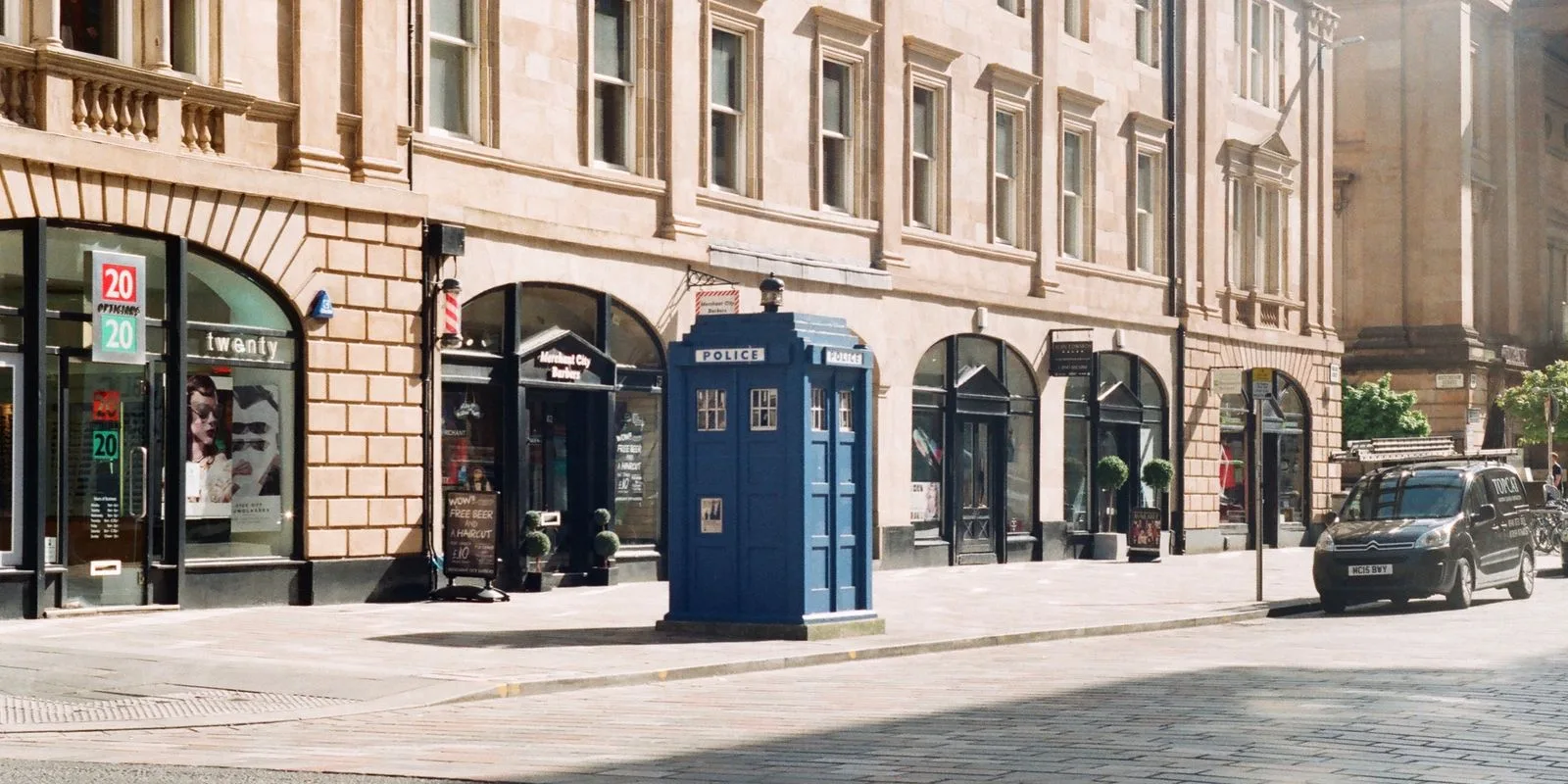 Glasgow city street with traditional stone commercial frontages