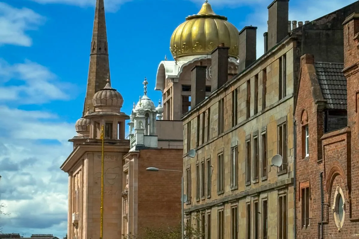 Commercial buildings on a Glasgow street under a blue sky