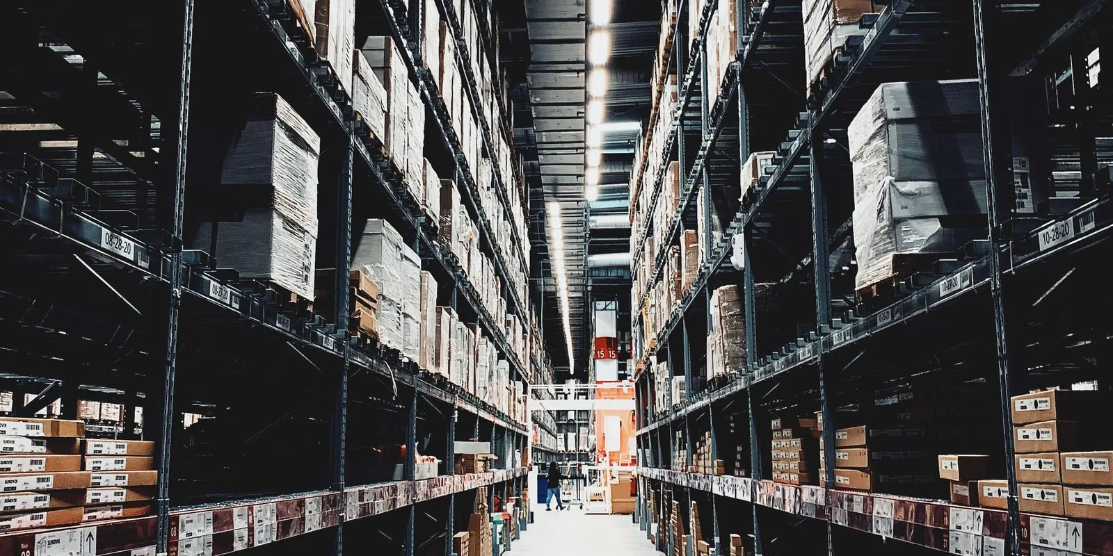 Aisle of stock boxes on high shelving in a retail warehouse