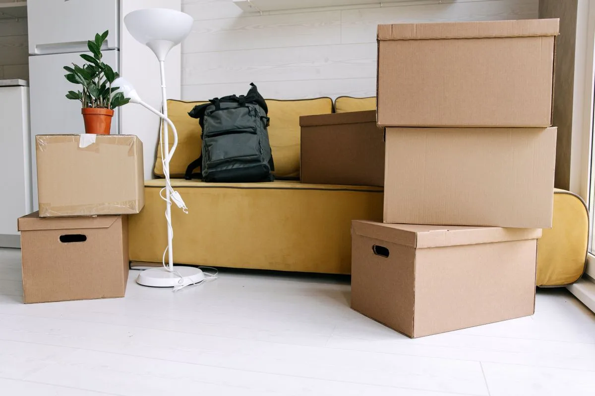 Sofa and packed boxes in a living room ready for a furniture removal