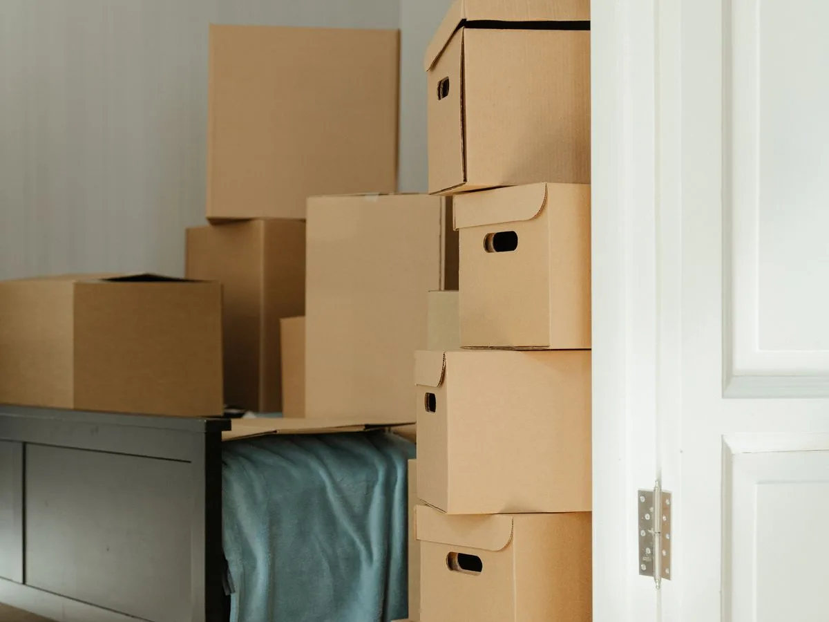 Packed boxes stacked in a bedroom during a home move