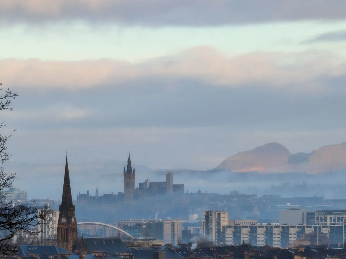 Glasgow city skyline at dawn with mist over the rooftops