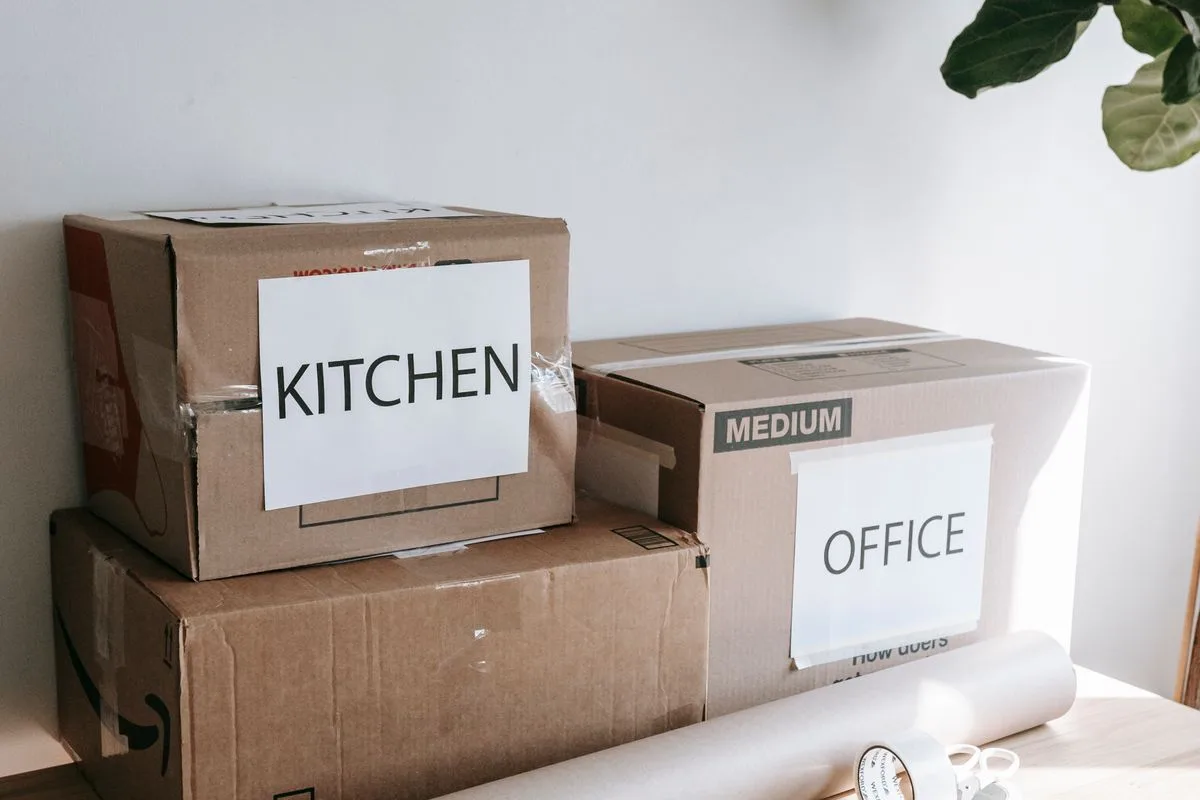 Cardboard boxes labelled by room ready for moving day
