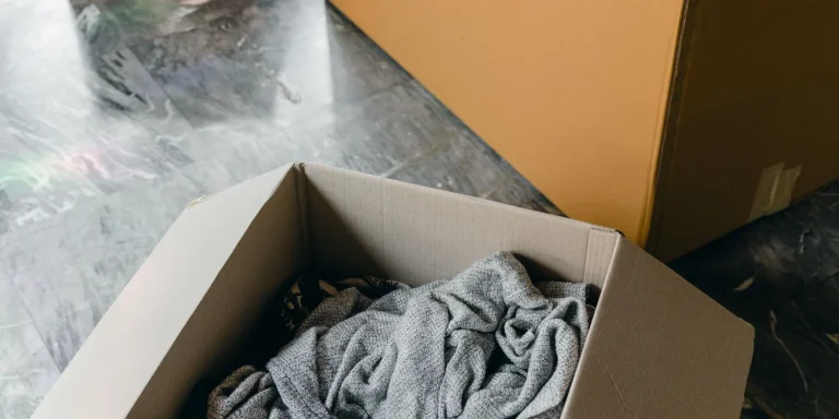Boxes of packed belongings on the floor of a new home after a move