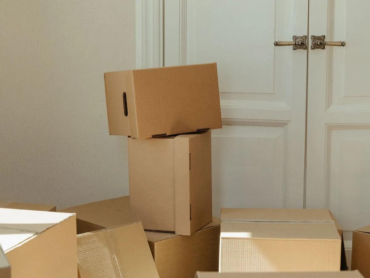Stack of moving boxes beside a front door ready for collection
