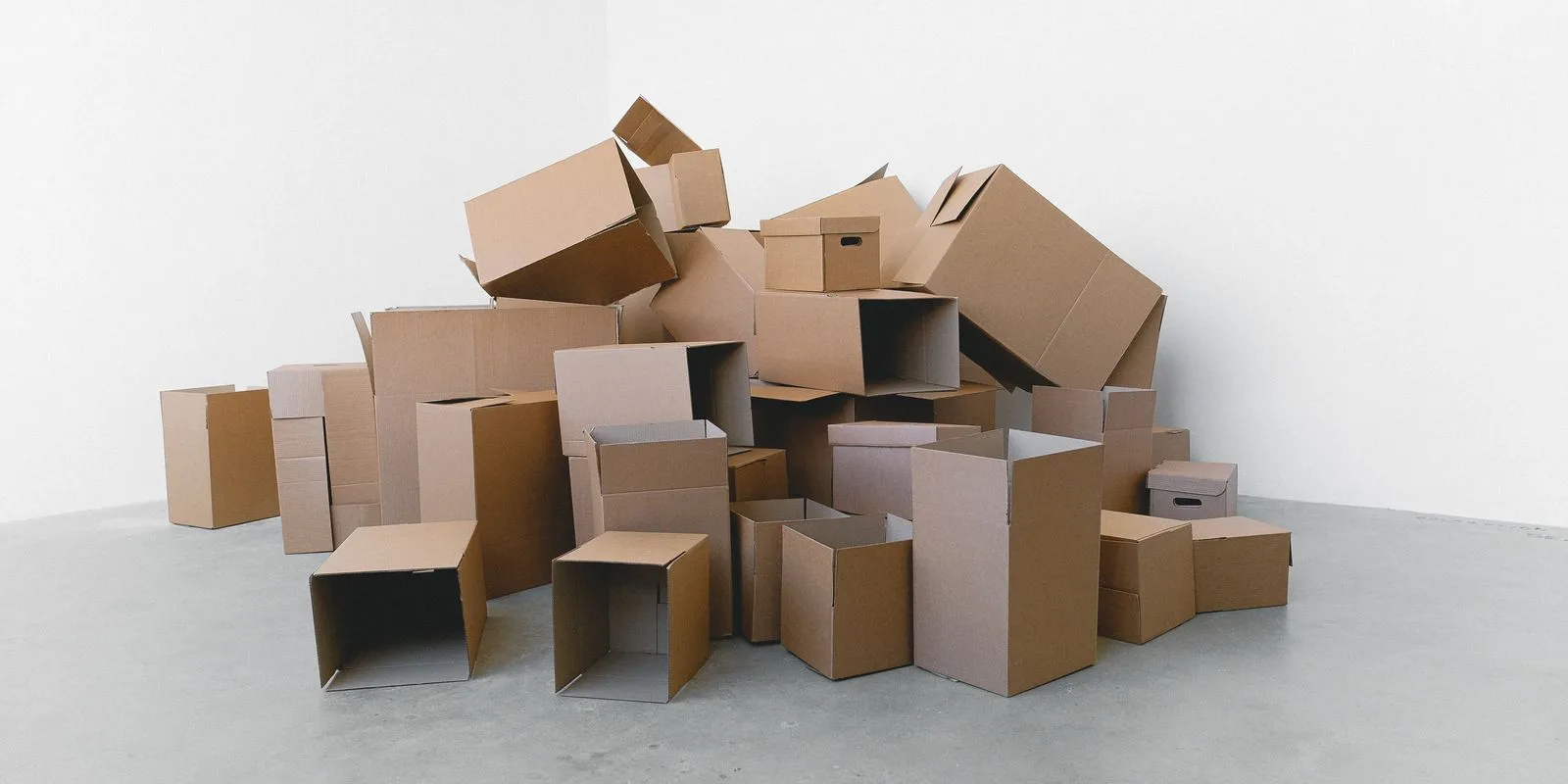 Cardboard cartons packed and stacked on the floor of a home ready for a move