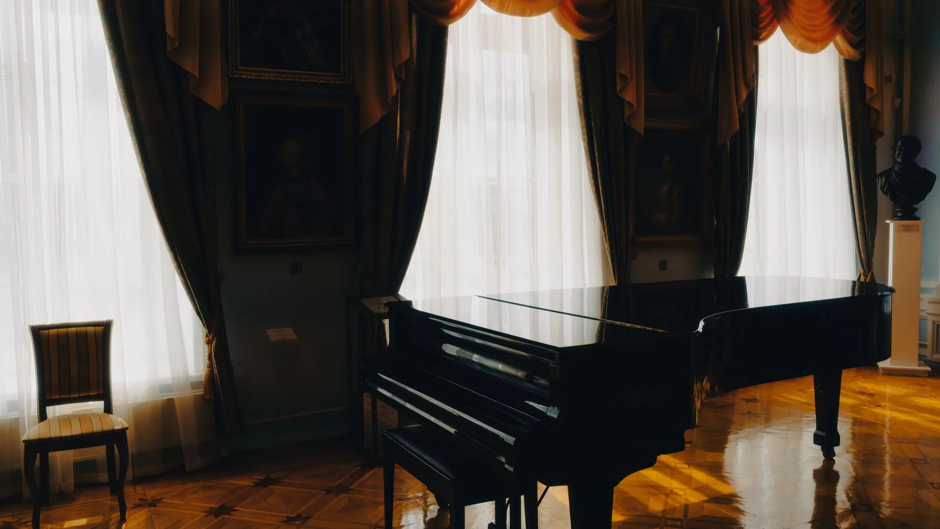 Grand piano standing in a sunlit room before a piano removal