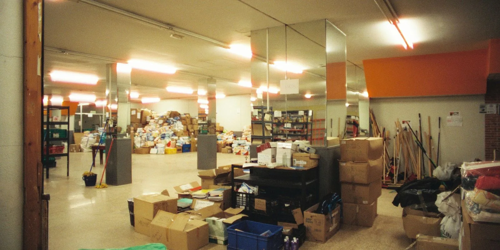 Boxes and household items stacked in a secure indoor storage area