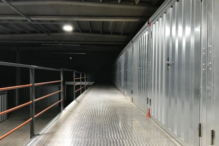 A row of unmarked steel doors along a storage building corridor