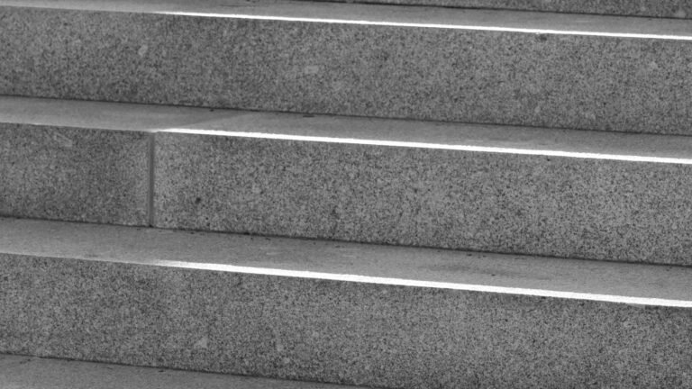 Close-up of plain granite steps, similar to a Glasgow tenement close