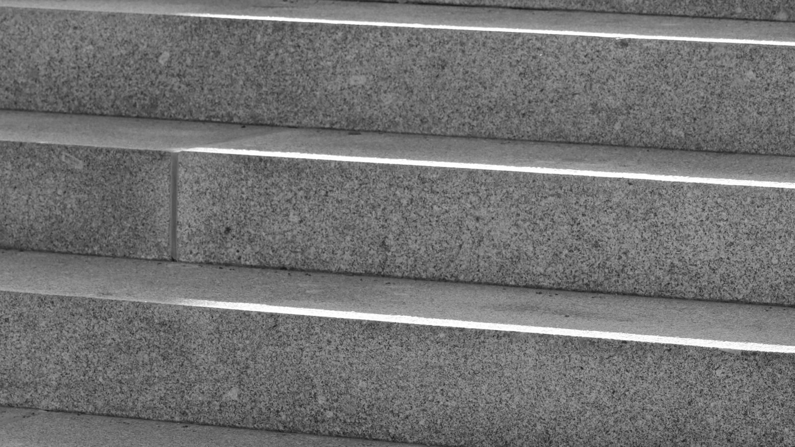 Close-up of plain granite steps, similar to a Glasgow tenement close